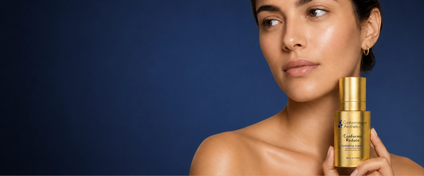 Woman holding a gold bottle of Conforma Reduce beside her jawline, a topical double chin treatment from Conformational Aesthetics