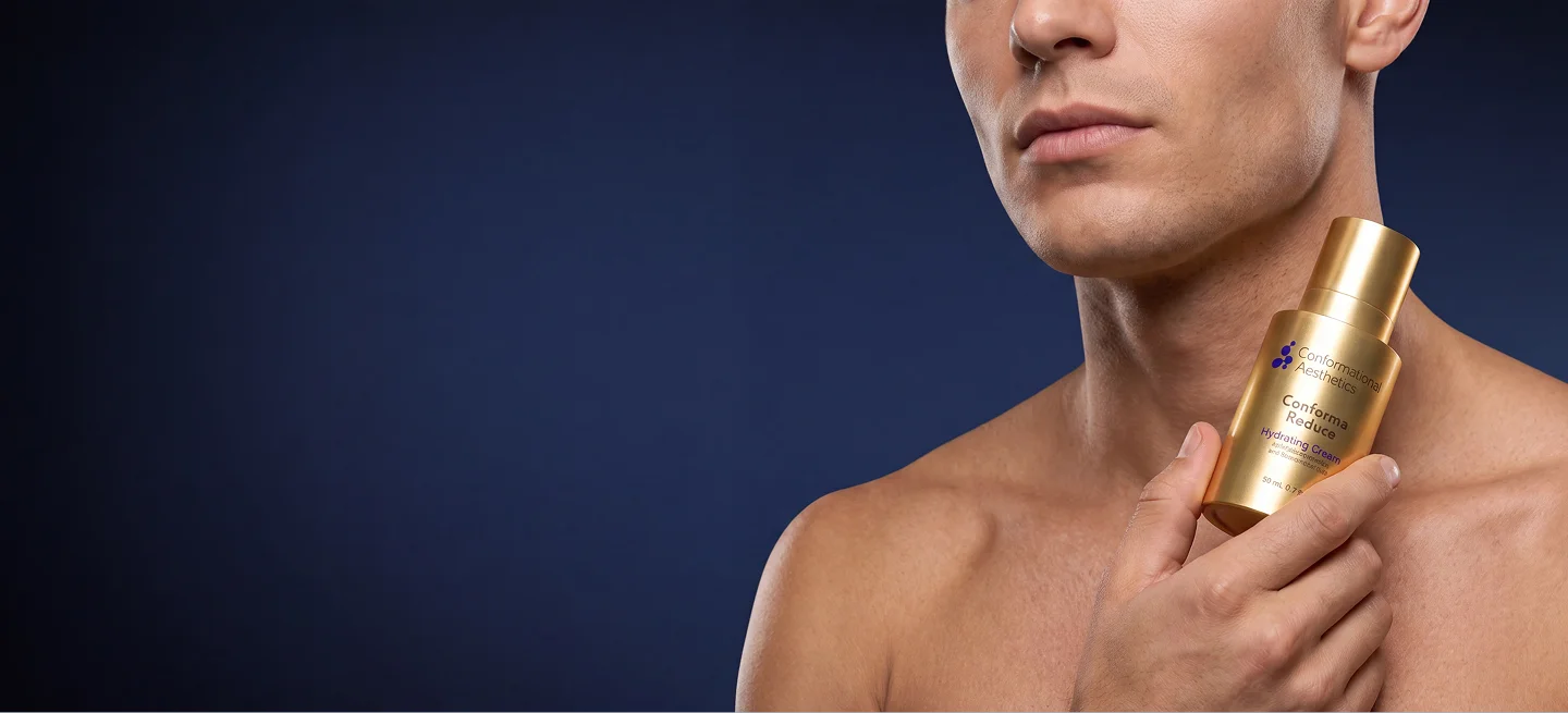 Man holding a bottle of Conforma Reduce beside his jawline