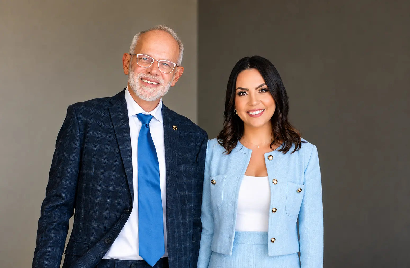 Conformational Aesthetics founders Ed Parsley, DO, and Jennifer Rosa standing together and smiling.